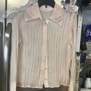 Beautiful pink and sheer blouse with large stylized cuffs